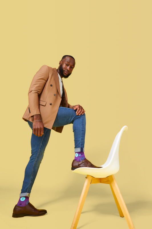 Purple socks. The Ghanaian name for the textile that inspired this design is Nsu Bra, an Akan word meaning "water well". The tiny dots are meant to resemble the ripples that are formed after water has been fetched.
In Nigeria, it is referred to as "disk" or "record" for obvious reasons.
In Togo, it is known as Gbedze, which references the straw hats worn as protection from the sun by royalty.