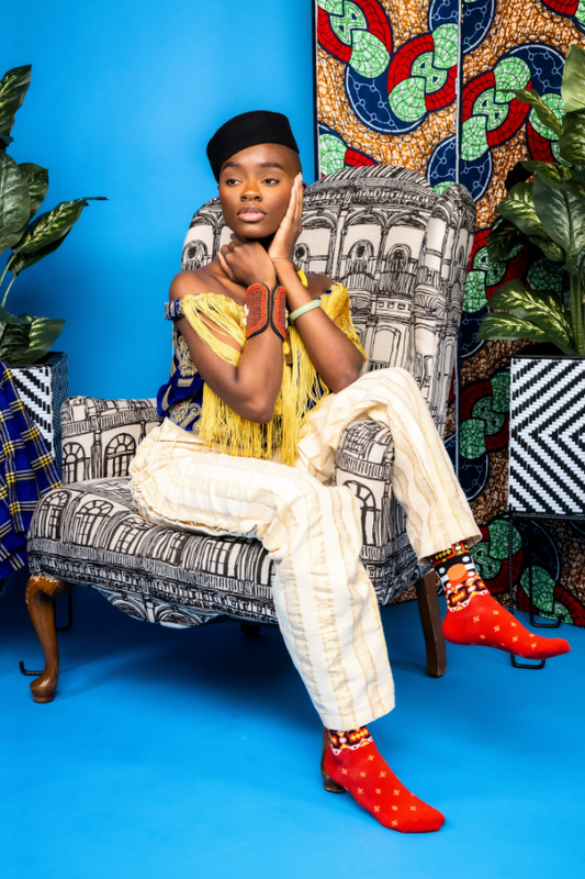 This design is inspired by the traditional Angolan textile print, called the “Samakaka”. There is little to no information as to the symbology of the fabric. However, the original print features colors from the Angolan flag but as time passed, additional colors were introduced. Red represents the blood shed by the people who fought for the anti colonization movement. The black represents the land or the African continent. The yellow or gold represents the country’s wealth.