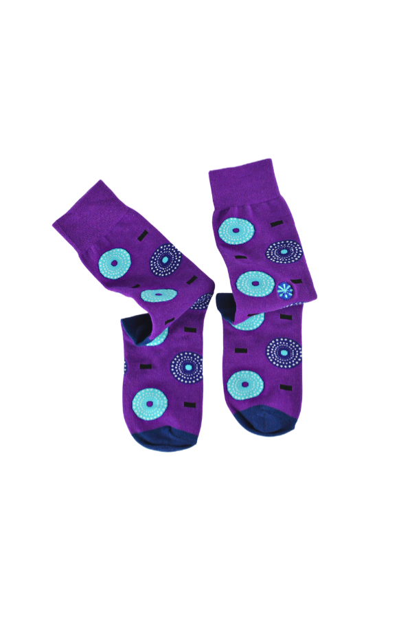 Purple socks. The Ghanaian name for the textile that inspired this design is Nsu Bra, an Akan word meaning "water well". The tiny dots are meant to resemble the ripples that are formed after water has been fetched.
In Nigeria, it is referred to as "disk" or "record" for obvious reasons.
In Togo, it is known as Gbedze, which references the straw hats worn as protection from the sun by royalty.