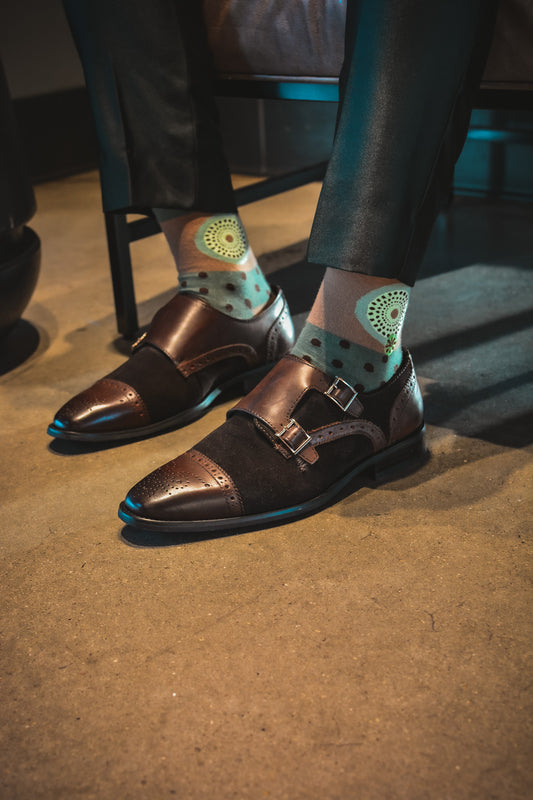 Green and brown socks. Insubra 3 is the third generation of the original Insubra. The Ghanaian name for the textile that inspired this design is Nsu Bra, an Akan word meaning "water well". The tiny dots are meant to resemble the ripples that are formed after water has been fetched.
In Nigeria, it is referred to as "disk" or "record" for obvious reasons.
In Togo, it is known as Gbedze, which references the straw hats worn as protection from the sun by royalty.