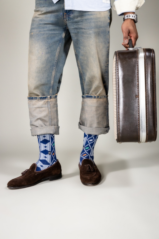 Our Awura socks takes inspiration from Ivory Coast's most notable tribe, the Baule tribe. They belong to the Akan group mainly associated with Ghana. In A.D. 1750 Queen Awura Pokou, along with her loyalists, migrated here from Ghana due to disputes over chieftaincy succession. 

With this design, we also wanted to highlight a little-known fact about the country - the cocoa plant is Ivory Coast's national resource and they produce and export more cocoa than anywhere else in the world.